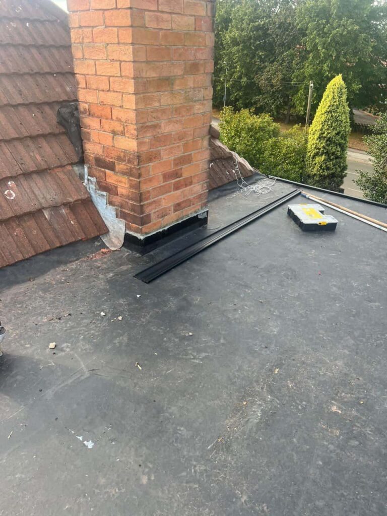 This is a photo of a flat roof which has just been repaired, there is also a chimney stack and some leadwork has also been dressed. Works carried out by LS Roofing Amersham
